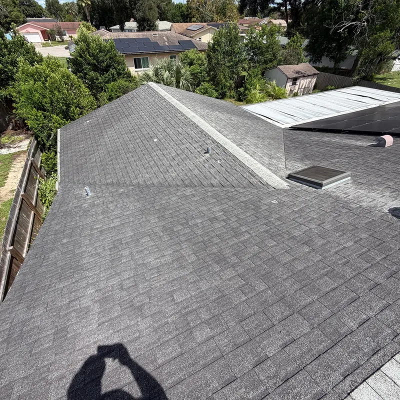 Worn gray shingle roof on a hip roof before a Pro Specialty Services re-roof, seen from the ridge